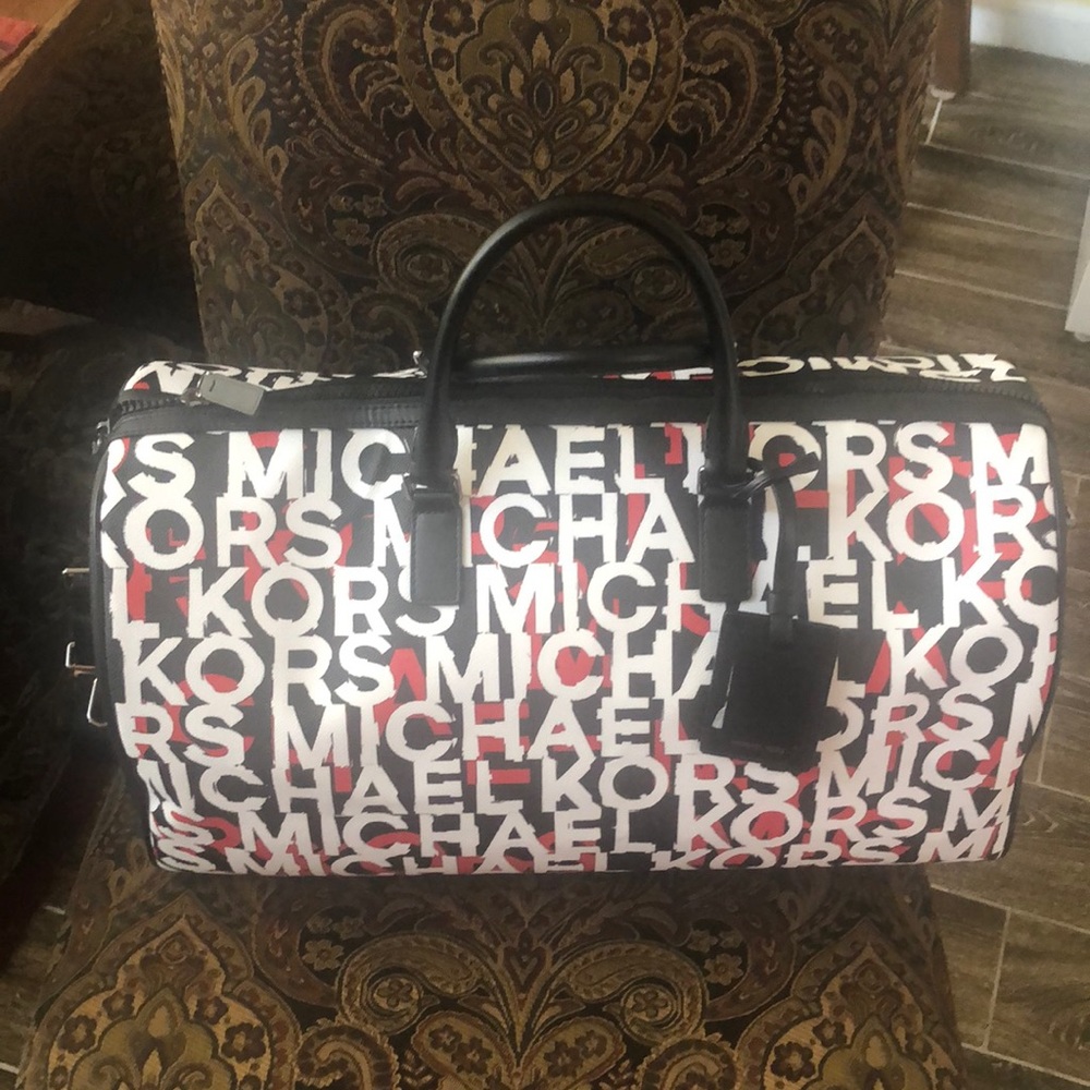 Black white and red Michael Kors weekender bag